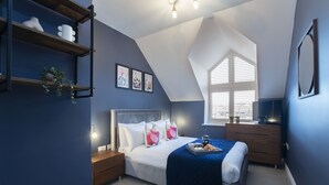 A bedroom with a bed, bedside tables, a dresser, a window, and a ceiling light fixture. - Elliot Oliver - Loft Style 2 Bedroom Apartment With Parking In The Docks (Gloucester)