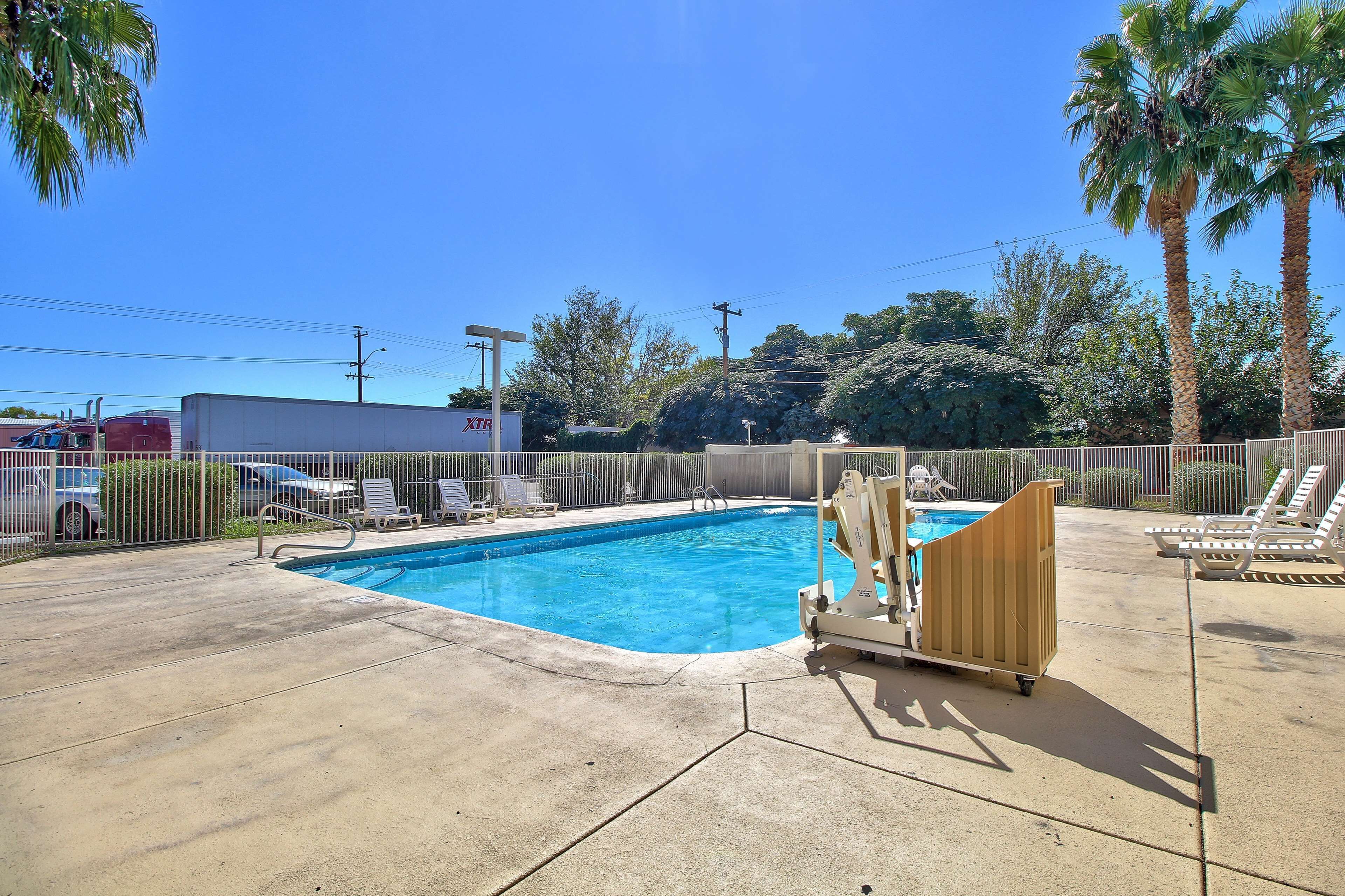 A swimming pool with lounge chairs and a changing station.