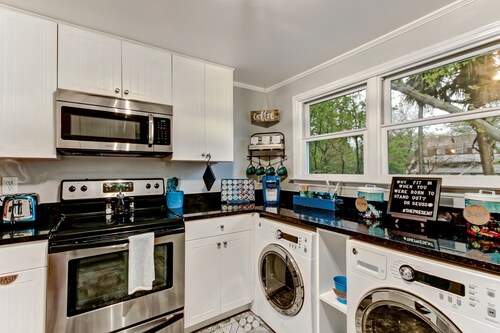 Vibrant, Colorful Condo Building With Backyard Firepit and Games