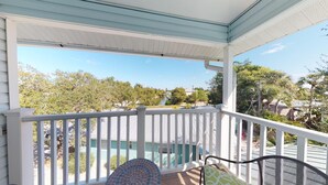 A covered porch with a view of a swimming pool and surrounding greenery. - AMAZING RATES & RAVE REVIEWS! Stunning private pool! 3min walk to the Beach 🏖 (Fort Myers Beach)