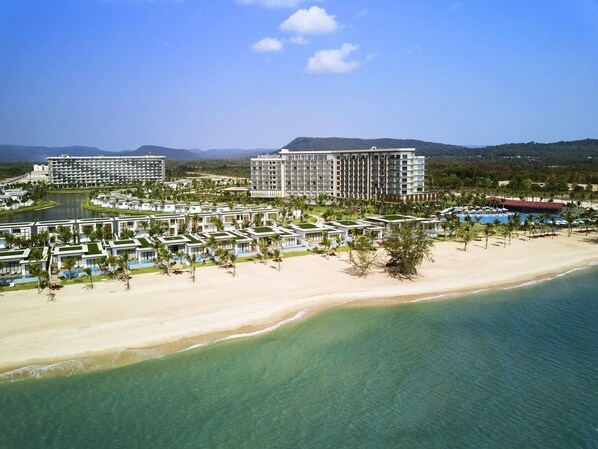 A resort with multiple buildings, a beach, and a pool area. - Mövenpick Villas & Residences  Phu Quoc (Phu Quoc)