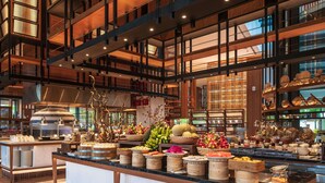 A spacious kitchen area with a central island, wooden beams, and a variety of food items displayed on the island. - Mövenpick Villas & Residences  Phu Quoc (Phu Quoc)