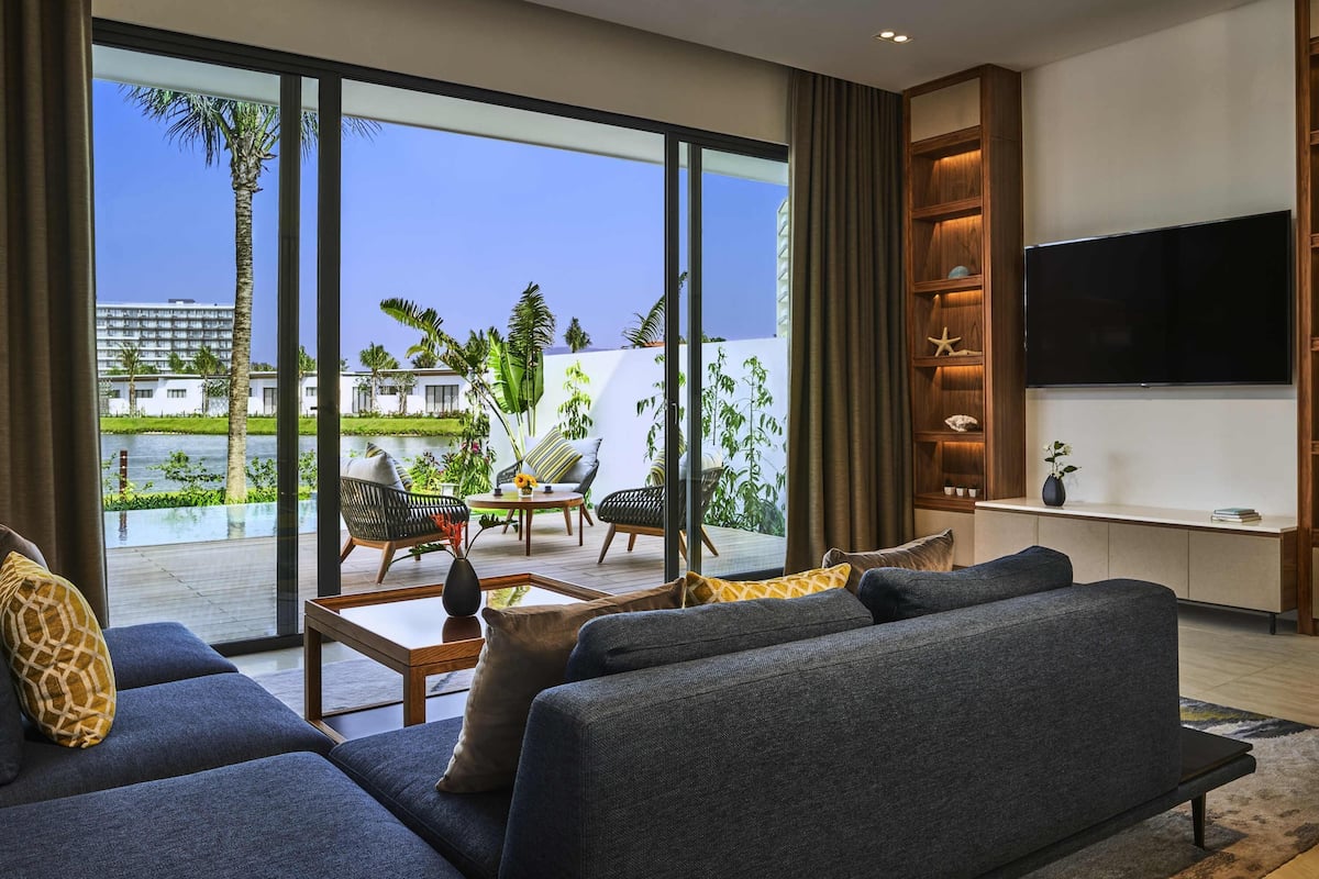 A modern living room with a sofa, coffee table, and TV.
