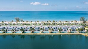A resort with multiple villas, a pool, and a view of the ocean. - Mövenpick Villas & Residences  Phu Quoc (Phu Quoc)