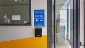 A blue sign with white text warning about video surveillance and advising not to assume vehicle and object responsibility inside.