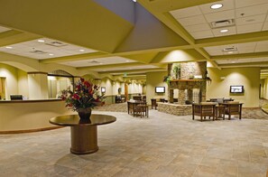 A spacious lobby with a reception desk, seating area, and a stone fireplace. - Wyndham Resort at Fairfield Mountains (Lake Lure)