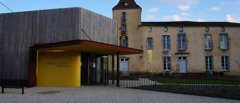 A building with a modern entrance and a traditional tower.