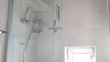 Shower, hair dryer, towels, toilet paper