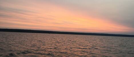 A calm body of water with a sunset.