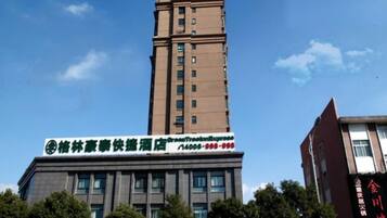 A multi-story building with a prominent sign for a hotel.
