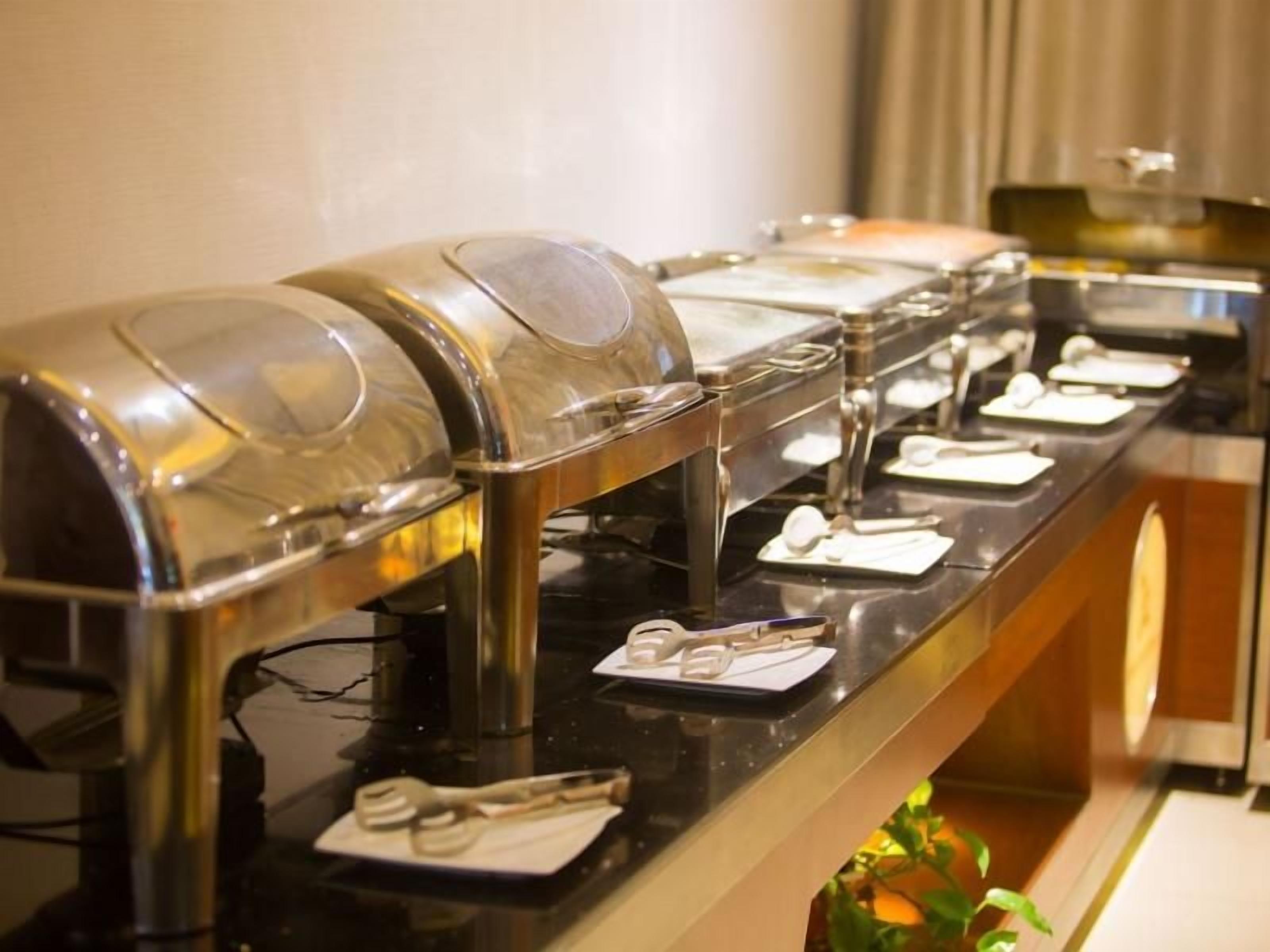 A buffet setup with multiple self-service food dispensers.