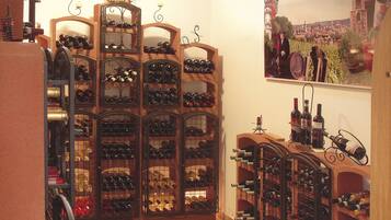 A wine cellar with multiple wooden wine racks filled with bottles.