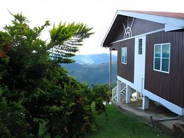 A modern two-story house with a view of mountains.