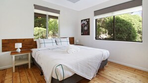 A bedroom with a bed, nightstands, a window, and a painting. - Cobden & Wills - In the heart of Bright (Bright)