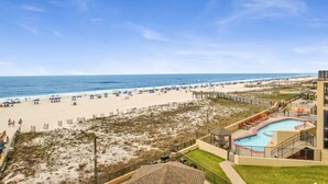 A beach resort with a swimming pool, beach access, and a view of the ocean. - Beachfront 1BR @ Phoenix IV • Sleeps 4 • Stunning Views, Balcony & Resort Amenities (Orange Beach)
