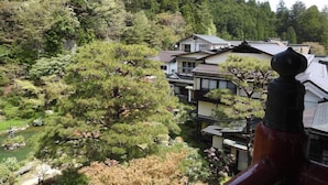 A traditional Japanese-style building with a view of a forested hillside. - Sekishoin (Koya)