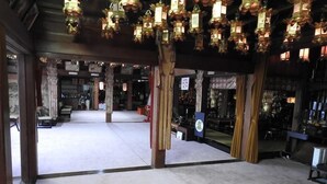 A spacious lobby with a high ceiling, decorative lanterns, and a central seating area. - Sekishoin (Koya)