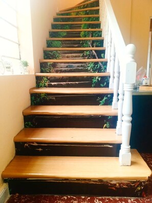A staircase with wooden steps and white balusters. - Hidden Garden - Hostel (Cusco)