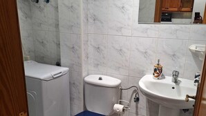 A bathroom with a toilet, sink, and mirror. - Las Galletas 2A, sun, beach, relaxation (Las Galletas)