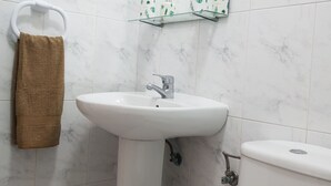 A bathroom with a white sink, a toilet, and a towel rack with a brown towel. - Las Galletas 2A, sun, beach, relaxation (Las Galletas)