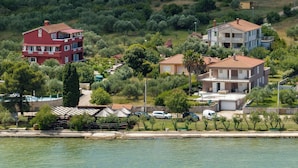 A coastal residential area with houses, a marina, and a small boat dock. - Apartments Saphron Beach (Pasman)