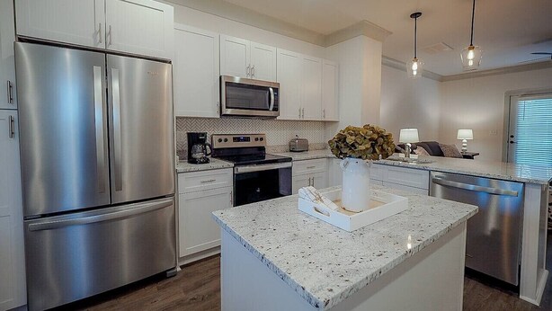 A modern kitchen with stainless steel appliances, a central island, and pendant lighting. - *2bd/2.5bth | Near Downtown| Soccer Stadium* #D (Nashville)