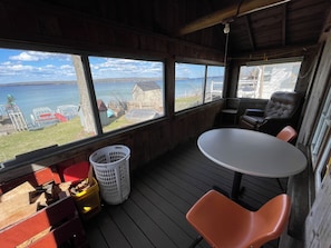 Enjoy a scenic lake view from the large window, with a round table for dining or socializing.