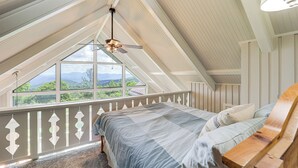 A bedroom with a large window, a ceiling fan, and a wooden headboard. - 1 Mi to Beech Mtn Ski Resort: Home w/ Large Yard (Beech Mountain)