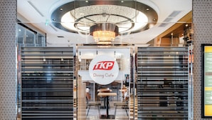 A TKP Dining Cafe with a modern interior, a chandelier, and a menu board on the wall. - APA Hotel Fukuoka Tenjin Nishi (Fukuoka)
