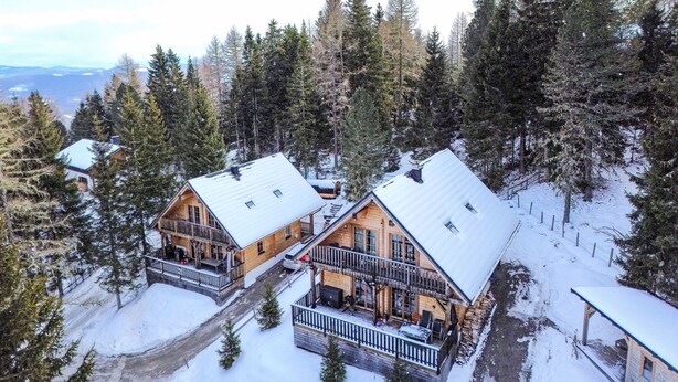 A cabin with a balcony and a covered porch, surrounded by snow and trees. - Almhaus Galisch by Interhome (Sirnitz - Hochrindl)
