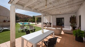 A covered patio area with a pool, outdoor furniture, and a view of the surrounding landscape. - Air-Conditioned Villa "Selena" with Pool, Garden & Wi-Fi (Pájara)