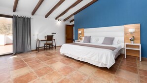 A bedroom with a bed, bedside tables, a desk, and a chair. - Air-Conditioned Villa "Selena" with Pool, Garden & Wi-Fi (Pájara)