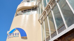 A hotel building with a curved facade, large windows, and a sign reading "Bridge Hotel Express." - Bridge Hotel Express (Cagayan de Oro)