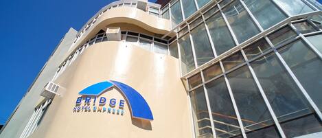 A hotel with a curved facade, large windows, and a prominent logo.