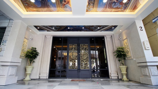 A grand entrance with ornate doors, a ceiling mural, and potted plants. - Hama Star (Kaohsiung)