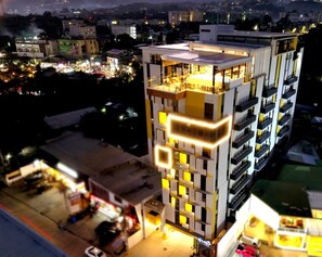 A multi-story building with a modern design, featuring balconies and a rooftop area. - Yello! Hotel (Cebu City)
