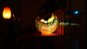 A decorative light fixture with a geometric design, possibly a lantern, in a dimly lit room. - Finest Hour Guesthouse (Chishang)