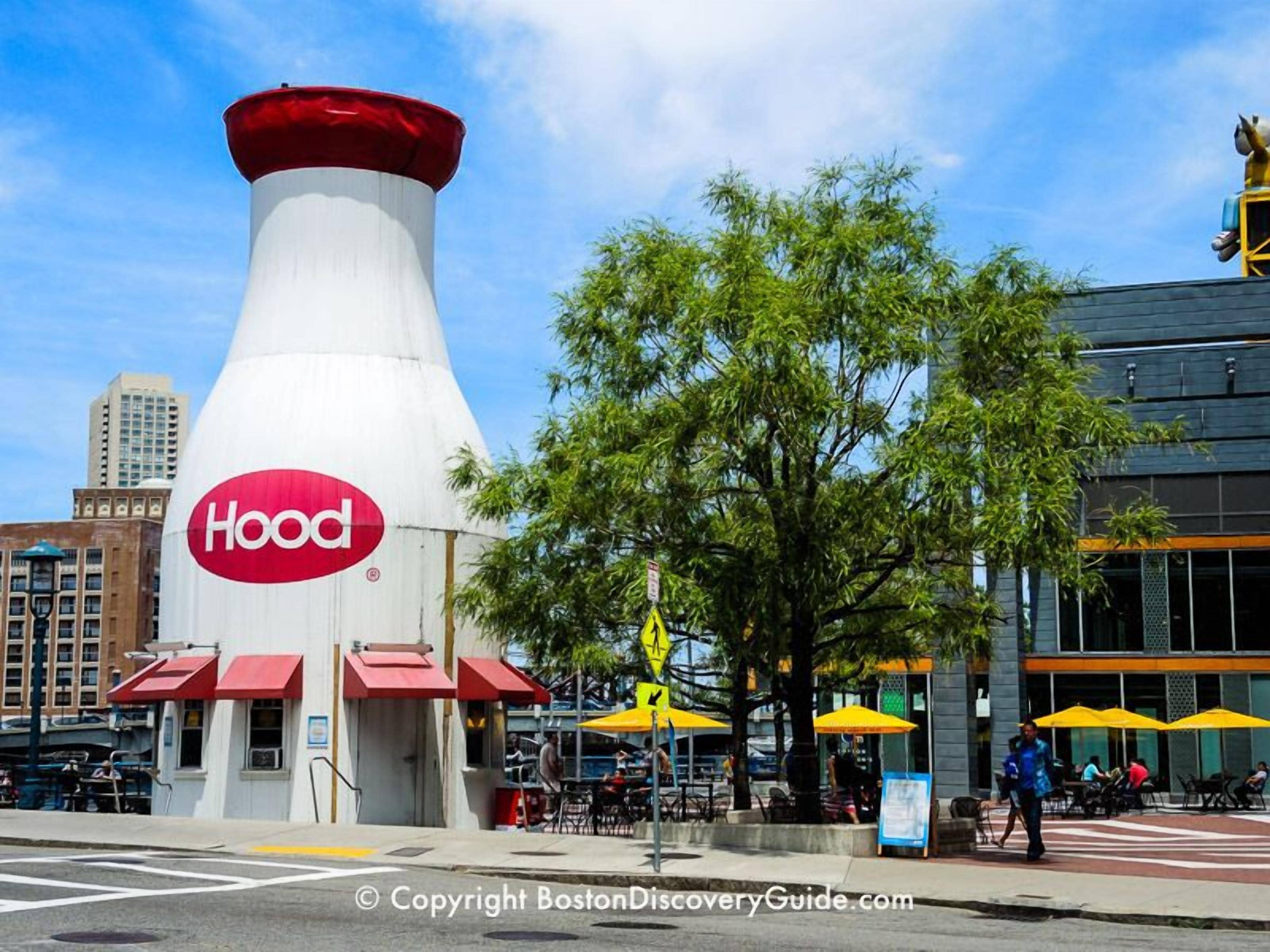 A building with a distinctive hood-shaped structure and a red awning, likely a restaurant or cafe.
