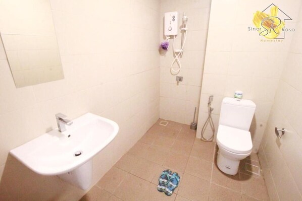 A bathroom with a sink, toilet, and shower.
