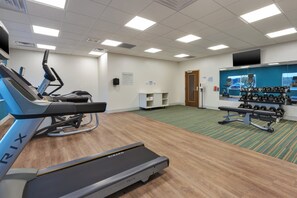 A fitness center with cardio equipment, weight machines, and a mirrored wall. - Holiday Inn Express & Suites Cedar Springs – Grand Rapids N by IHG (Cedar Springs)