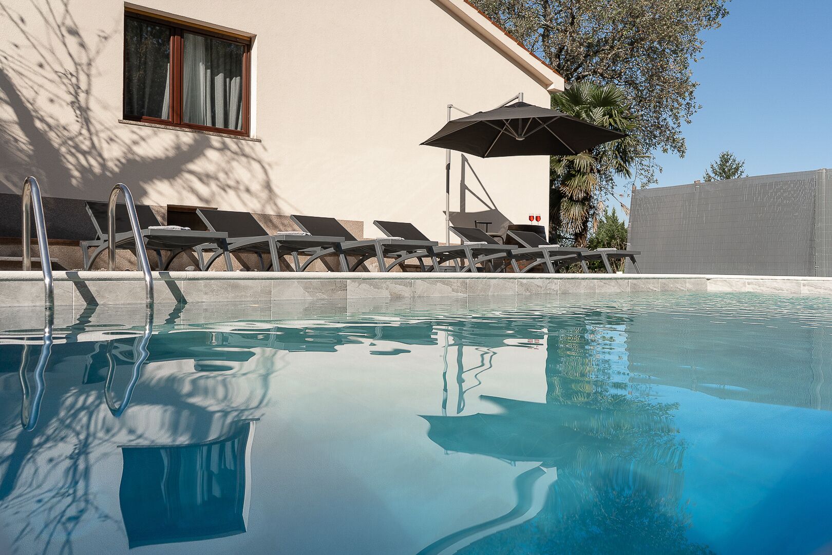 Outdoor pool, a heated pool, sun loungers