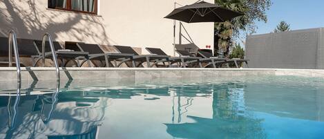 Outdoor pool, a heated pool, sun loungers