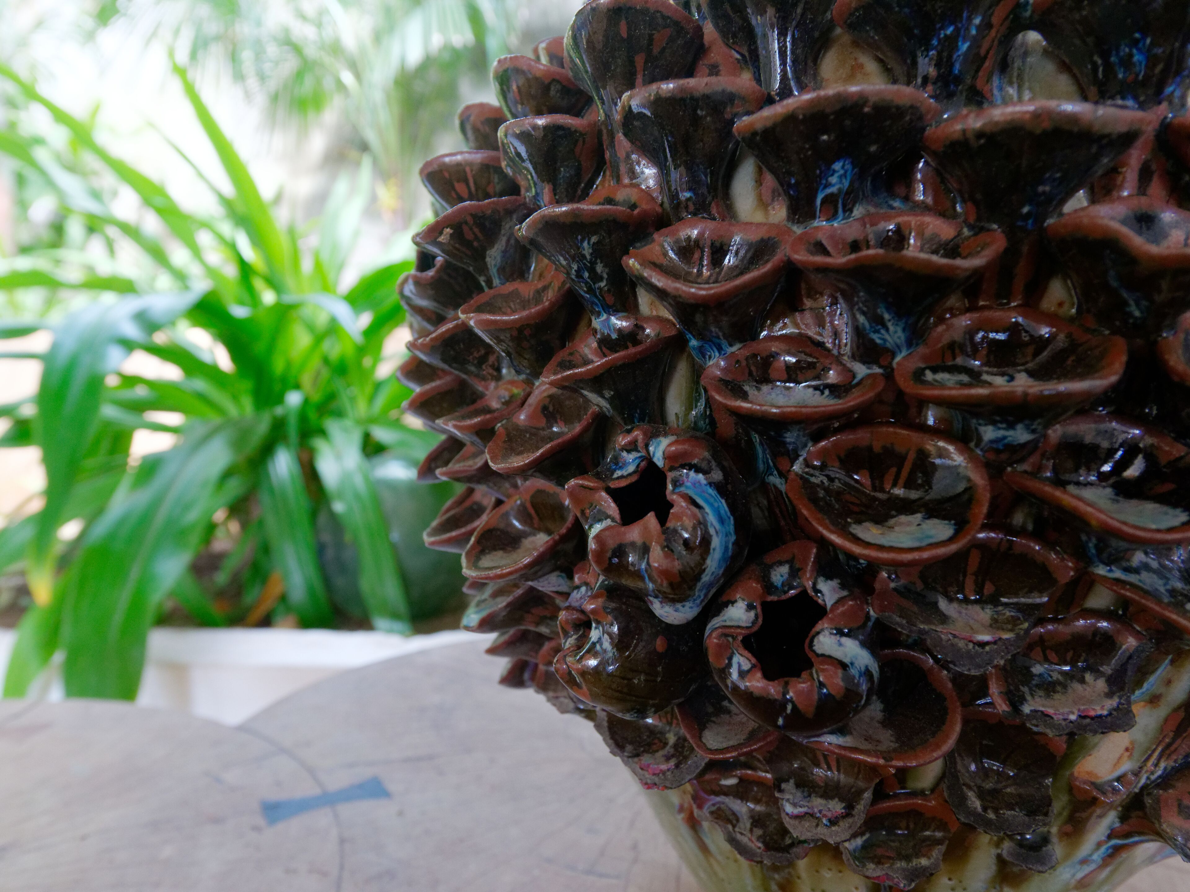 A close-up of a decorative ceramic object with a spiral design, possibly a sculpture or a piece of art.