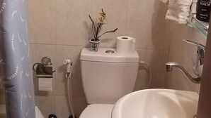 Ein Badezimmer mit Toilette, Waschbecken und Handtuchhalter.