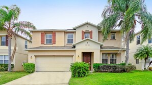 A two-story residential building with a beige facade, red shutters, and a garage. - Ev8080ha - Highgate at Legacy Park - 6 Bed 5.5 Baths Villa (Davenport)