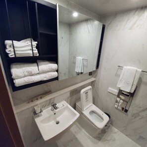 A modern bathroom with a sink, toilet, and towel rack. - SOTA SUITE SOKCHO WORLDSTATE (Sokcho)
