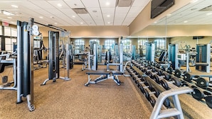 A gym with various exercise equipment, including weight machines and dumbbells. - Ev8117ha - Storey Lake Resort - 9 Bed 5 Baths Villa (Kissimmee)