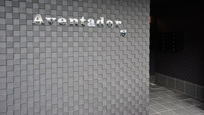 Pared de azulejos con el nombre "Aventadors" en letras metálicas.