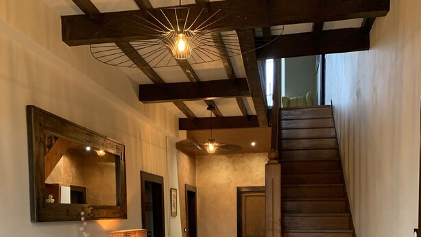A spacious hallway with a marble floor, a wooden staircase, and a modern pendant light. - La Maison d'Amalaurille (Estancarbon)