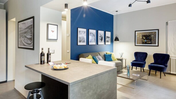 A modern living room with a central island, a sofa, and two armchairs. - Bluechiaia apartment- close to everything. (Napoli)